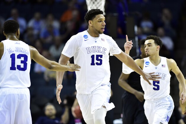 Mar 22, 2015; Charlotte, NC, USA; Duke Blue Devils center Jahlil Okafor (15) celebrates with guard Matt Jones (13) and guard Tyus Jones (5) during the second half against the San Diego State Aztecs in the third round of the 2015 NCAA Tournament at Time Warner Cable Arena. Mandatory Credit: Bob Donnan-USA TODAY Sports