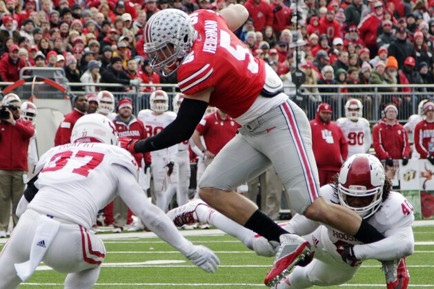 Ohio State tight end Jeff Heuerman, center, is tackled by Indiana defenders Mark Murphy, left, and Antonio Allen during the first quarter of an NCAA college football game Saturday, Nov. 22, 2014, in Columbus, Ohio. (AP Photo/Jay LaPrete)