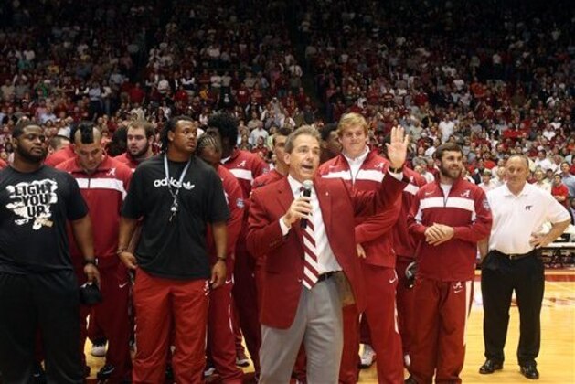 Alabama football coach Nick Saban talks to fans during halftime of the NCAA college basketball game between Auburn and Alabama at Coleman Coliseum in Tuscaloosa, Ala., Wednesday, Feb. 29, 2012. (AP Photo/Michelle Lepianka Carter)