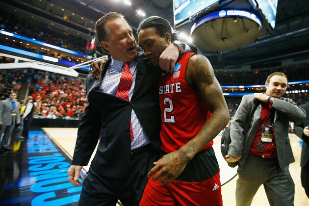PITTSBURGH, PA - MARCH 21: Head coach Mark Gottfried walks off the floor with Anthony Barber #12 of the North Carolina State Wolfpack following their 71-68 win over the Villanova Wildcats during the third round of the 2015 NCAA Men's Basketball Tournament at Consol Energy Center on March 21, 2015 in Pittsburgh, Pennsylvania.  (Photo by Jared Wickerham/Getty Images)