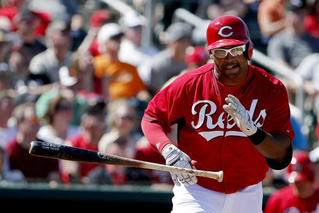 Cincinnati Reds' Marlon Byrd tosses his bat away as he hits a pop fly against the San Francisco Giants during the third inning of a spring training baseball game Monday, March 16, 2015, in Goodyear, Ariz.  The fly ball dropped in for a hit as San Francisco Giants' Justin Maxwell lost the ball in the sun. (AP Photo/Ross D. Franklin)
