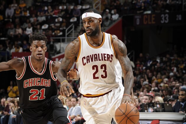 CLEVELAND, OH - JANUARY 19:  LeBron James #23 of the Cleveland Cavaliers brings the ball up court against Jimmy Butler #21 of the Chicago Bulls on January 19, 2015 at The Quicken Loans Arena in Cleveland, Ohio. NOTE TO USER: User expressly acknowledges and agrees that, by downloading and or using this Photograph, user is consenting to the terms and conditions of the Getty Images License Agreement. Mandatory Copyright Notice: Copyright 2015 NBAE (Photo by David Liam Kyle/NBAE via Getty Images)