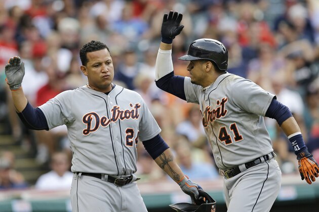 Detroit Tigers' Victor Martinez, right, and Miguel Cabrera celebrate after Martinez hit a two-run home run off Cleveland Indians starting pitcher Corey Kluber in the third inning of a baseball game, Monday, Sept. 1, 2014, in Cleveland. Cabrera scored on the play. (AP Photo/Tony Dejak)