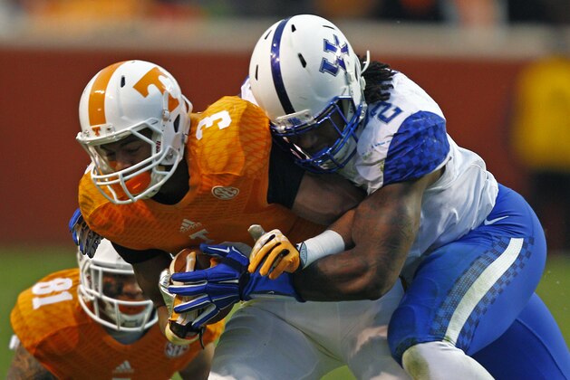 Tennessee wide receiver Josh Malone (3) runs for yardage as he's hit by Kentucky defensive end Alvin Dupree (2) during an NCAA college football game Saturday, Nov. 15, 2014 in Knoxville, Tenn. (AP Photo/Wade Payne)