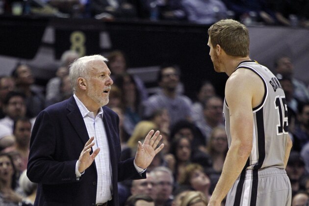 San Antonio Spurs' head coach Gregg Popovich, left, talks with the Spurs' Matt Bonner, after Bonner was called for a technical foul, during the third quarter of an NBA basketball game against the Boston Celtics, Friday, March 20, 2015, in San Antonio. The foul was withdrawn after a video review. (AP Photo/Michael Thomas)