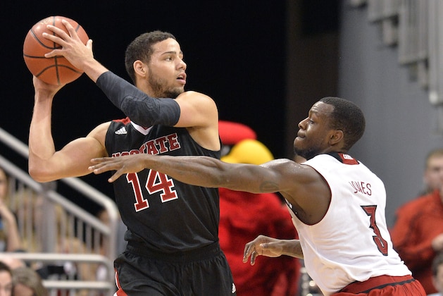 North Carolina State's Caleb Martin, left, looks for help from the defense of Louisvile's Chris Jones during the second half of an NCAA college basketball game Saturday, Feb. 14, 2015 in Louisville, Ky. NC State won 74-65. (AP Photo/Timothy D. Easley)