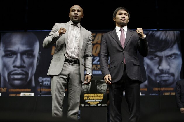Floyd Mayweather Jr., left, and Manny Pacquiao, of the Philippines, pose for photos after a news conference, Wednesday, March 11, 2015, in Los Angeles. The two are scheduled to fight in Las Vegas on May 2. (AP Photo/Jae C. Hong)
