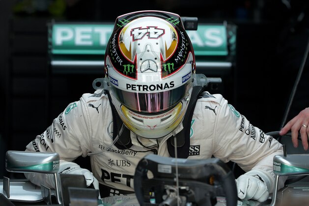 Mercedes driver Lewis Hamilton of Britain gets up from his car after after the second practice session for the Malaysian Formula One Grand Prix at Sepang International Circuit in Sepang, Malaysia Friday, March 27, 2015. (AP Photo/Andy Wong)
