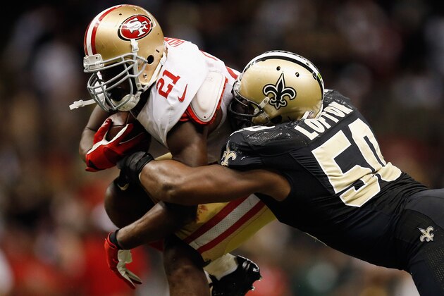 NEW ORLEANS, LA - NOVEMBER 25:   Frank Gore #21 of the San Francisco 49ers is tackled by  Curtis Lofton #50 of the New Orleans Saints at The Mercedes-Benz Superdome on November 25, 2012 in New Orleans, Louisiana.  The 49ers defeated the Saints 31-21.  (Photo by Chris Graythen/Getty Images)
