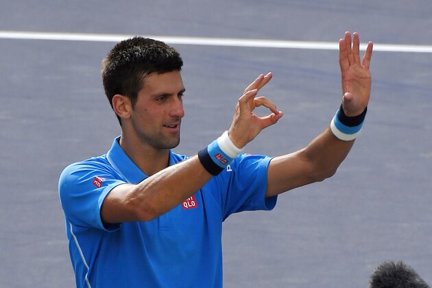 Novak Djokovic, of Serbia, gestures the number 50 with his hands after his 6-3, 6-7 (5), 6-2 win over Roger Federer, of Switzerland, in the men's final at the BNP Paribas Open tennis tournament, Sunday, March 22, 2015, in Indian Wells, Calif. This is Djokovic's 50th career ATP Tour title. (AP Photo/Mark J. Terrill)