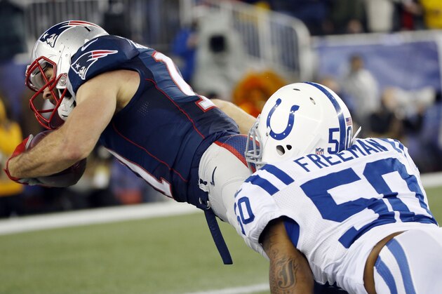 New England Patriots wide receiver Julian Edelman is tackled by Indianapolis Colts inside linebacker Jerrell Freeman (50) during the first half of the NFL football AFC Championship game Sunday, Jan. 18, 2015, in Foxborough, Mass. (AP Photo/Elise Amendola)