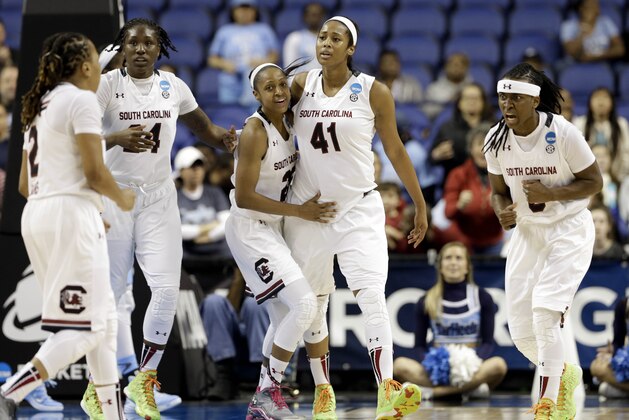 South Carolina's Olivia Gaines (2), from left, Aleighsa Welch, Tiffany Mitchell, Alaina Coates (41) and Khadijah Sessions react near the end of a women's college basketball regional semifinal game against North Carolina in the NCAA Tournament Greensboro, N.C., Friday, March 27, 2015. South Carolina won 67-65. (AP Photo/Gerry Broome)