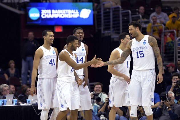 Kentucky's Andrew Harrison is congratulated by Willie Cauley-Stein (15) during the second half of a college basketball game against West Virginia in the NCAA men's tournament regional semifinals, Thursday, March 26, 2015, in Cleveland. (AP Photo/David Richard)