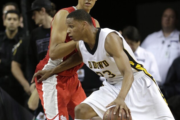 Bishop O' Dowd forward Ivan Rabb, right, drives to the basket against Mater Dei center Michael Cage during the second half of the boys' Open Division CIF basketball championship game Saturday, March 29, 2014, in Sacramento, Calif.  Mater Dei won 71-61.(AP Photo/Rich Pedroncelli)