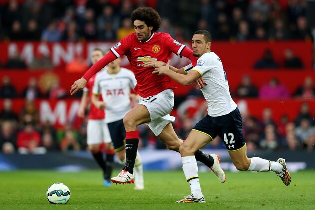 MANCHESTER, ENGLAND - MARCH 15:  Marouane Fellaini of Manchester United is challenged by Nabil Bentaleb of Spurs during the Barclays Premier League match between Manchester United and Tottenham Hotspur at Old Trafford on March 15, 2015 in Manchester, England.  (Photo by Alex Livesey/Getty Images)