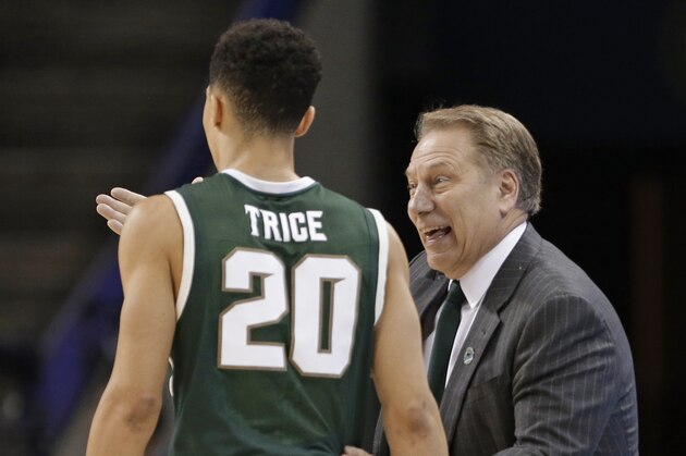 Michigan State head coach Tom Izzo, right, talks with Travis Trice, left, during the second half of an NCAA tournament college basketball game in the Round of 32 in Charlotte, N.C., Sunday, March 22, 2015. (AP Photo/Gerald Herbert)