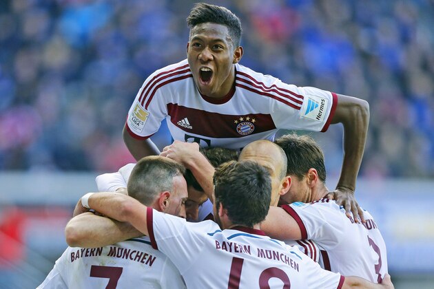 Munichs teammates celebrate with David Alaba on top,  after scoring during the German first division Bundesliga soccer match between SC Paderborn and Bayern Munich in Paderborn, Germany, Saturday, Feb. 21, 2015. (AP Photo/Frank Augstein)