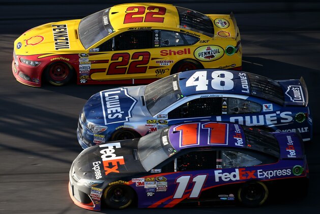 DAYTONA BEACH, FL - FEBRUARY 22:  Joey Logano, driver of the #22 Shell Pennzoil Ford, Jimmie Johnson, driver of the #48 Lowe's Chevrolet, and Denny Hamlin, driver of the #11 FedEx Express Toyota, race three-wide during the NASCAR Sprint Cup Series 57th Annual Daytona 500 at Daytona International Speedway on February 22, 2015 in Daytona Beach, Florida.  (Photo by Patrick Smith/Getty Images)