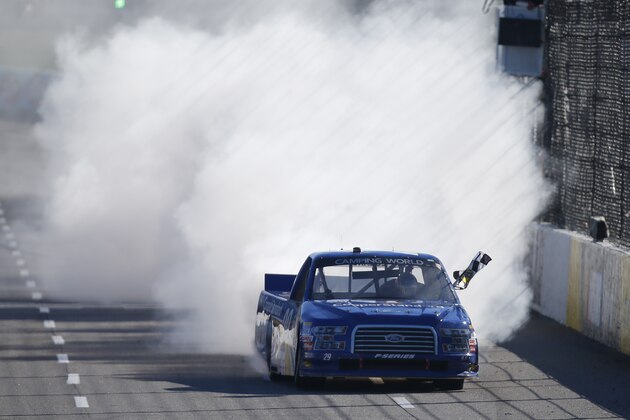 MARTINSVILLE, VA - MARCH 28:  Joey Logano, driver of the #29 Cooper Standard Ford, celebrates with the checkered flag after winning the NASCAR Camping World Truck Series Kroger 250 at Martinsville Speedway on March 28, 2015 in Martinsville, Virginia.  (Photo by Matt Sullivan/Getty Images)