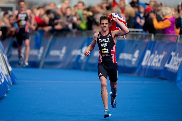 STOCKHOLM, SWEDEN - AUGUST 23: Jonathan Brownlee from Great Britain arrives to the finish line with the Union Jack flah handled at the Elite Men Sprin Race during the ITU World Triathlon on August 23, 2014 in Stockholm, Sweden. (Photo by Gonzalo Arroyo Moreno/Getty Images for Threadneedle)