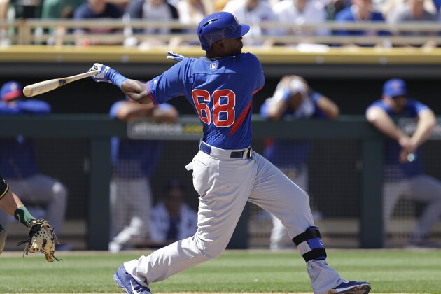 Oakland Athletics' Chicago Cubs' Jorge Soler swings for an RBI single off Oakland Athletics' Drew Pomeranz in the first inning of a spring training exhibition baseball game Tuesday, March 24, 2015, in Mesa, Ariz. (AP Photo/Ben Margot)