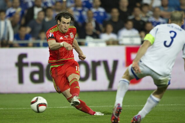 Wales' Gareth Bale makes a free kick against Israel during Euro 2016 group B qualifying soccer match in Haifa, Israel, Saturday, March 28, 2015. (AP Photo/Ariel Schalit)