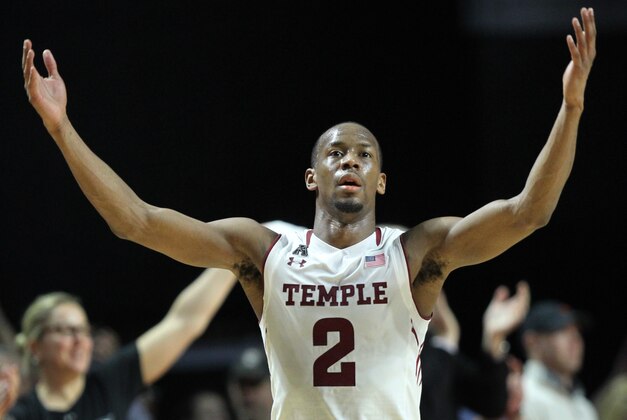 Temple guard Will Cummings (2) raises his hands to celebrate after defeating Connecticut 75-63 in an NCAA college basketball game, Saturday, March 7, 2015, in Philadelphia. (AP Photo/Laurence Kesterson)