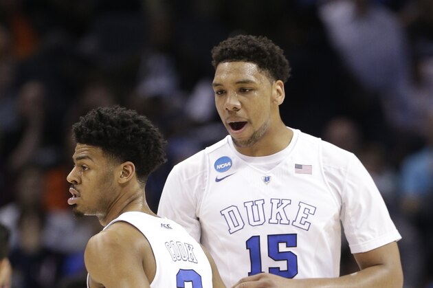 Duke's Jahlil Okafor (15) and Quinn Cook (2) celebrates during the first half of an NCAA tournament college basketball game  against San Diego State in the Round of 32 in Charlotte, N.C., Sunday, March 22, 2015.  (AP Photo/Nell Redmond)