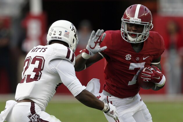 Alabama wide receiver Cam Sims (7) tries to get around Texas A&M Armani Watts (23) during the second half of an NCAA college football game on Saturday, Oct. 18, 2014, in Tuscaloosa, Ala. (AP Photo/Butch Dill)