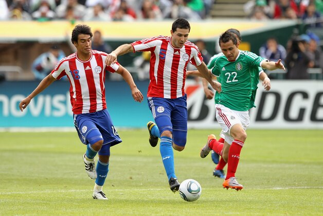 OAKLAND, CA - MARCH 26:  Paul Aguilar of Mexico and Antolin Alcaraz and Marcelo Estigarribia of Paraguay go for the ball during their international friendly match at Oakland-Alameda County Coliseum on March 26, 2011 in Oakland, California.  (Photo by Ezra Shaw/Getty Images)