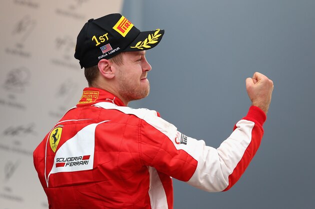 KUALA LUMPUR, MALAYSIA - MARCH 29:  Sebastian Vettel of Germany and Ferrari celebrates on the podium after winning the Malaysia Formula One Grand Prix at Sepang Circuit on March 29, 2015 in Kuala Lumpur, Malaysia.  (Photo by Clive Mason/Getty Images)