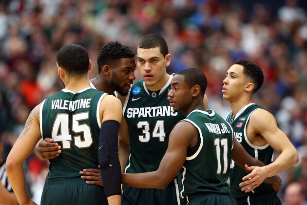 SYRACUSE, NY - MARCH 29:  Branden Dawson #22 of the Michigan State Spartans talks with his teammates in a huddle against the Louisville Cardinals during the East Regional Final of the 2015 NCAA Men's Basketball Tournament at Carrier Dome on March 29, 2015 in Syracuse, New York.  (Photo by Maddie Meyer/Getty Images)