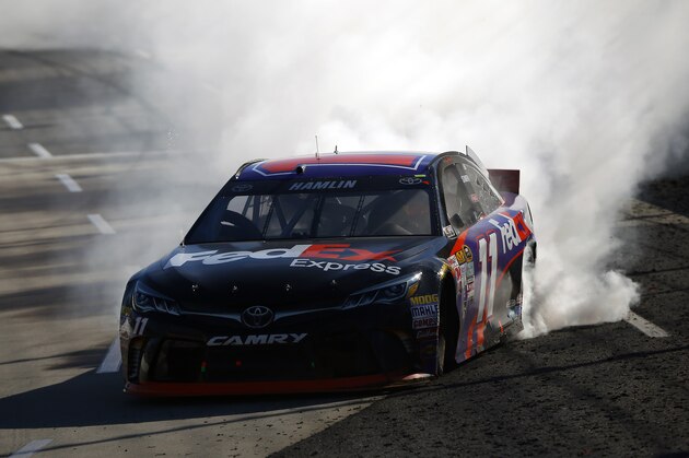 MARTINSVILLE, VA - MARCH 29:  Denny Hamlin, driver of the #11 FedEx Express Toyota, celebrates with a burnout after winning the NASCAR Sprint Cup Series STP 500 at Martinsville Speedway on March 29, 2015 in Martinsville, Virginia.  (Photo by Matt Sullivan/Getty Images)