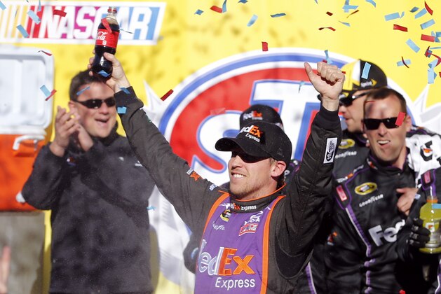 Denny Hamlin celebrates winning  the NASCAR Sprint Cup race at Martinsville Speedway in Martinsville, Va., Sunday, March 29, 2015. (AP Photo/Steve Helber)