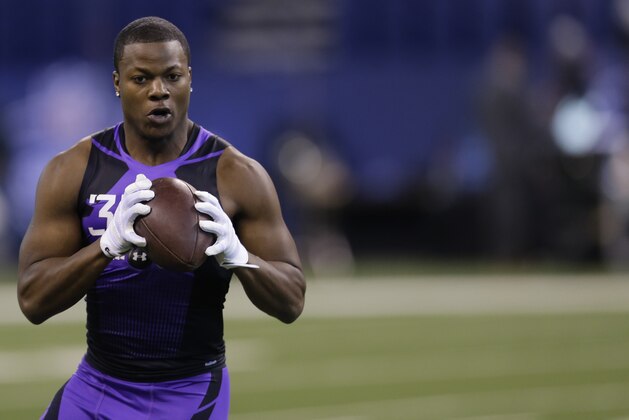 Washington defensive back Marcus Peters runs a drill at the NFL football scouting combine in Indianapolis, Monday, Feb. 23, 2015. (AP Photo/Julio Cortez)