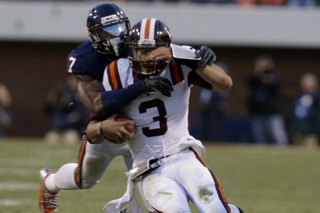 Virginia defensive end Eli Harold (7) tackles Virginia Tech quarterback Logan Thomas (3) during the first half of an NCAA college football game in Charlottesville, Va., Saturday, Nov. 30, 2013. (AP Photo/Steve Helber)