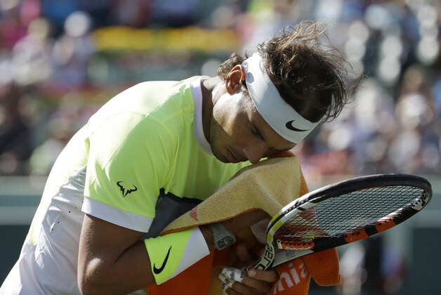 Rafael Nadal, of Spain, towels off during his match against Fernando Verdasco, of Spain, at the Miami Open tennis tournament, Sunday, March 29, 2015, in Key Biscayne, Fla. Verdasco won 6-4, 2-6, 6-3. (AP Photo/Lynne Sladky)