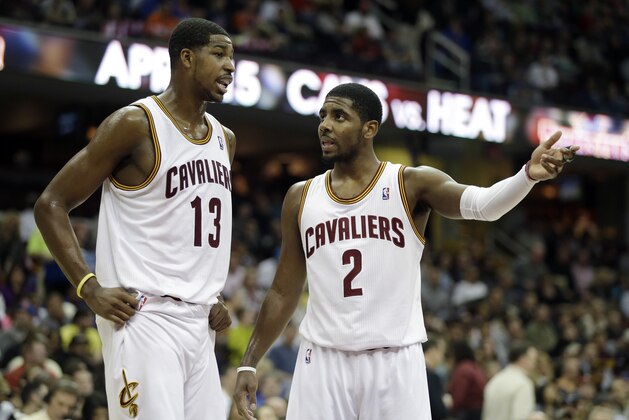 Cleveland Cavaliers' Kyrie Irving (2) talks with Tristan Thompson (13) during an NBA basketball game against the New York Knicks Friday, April 12, 2013, in Cleveland. (AP Photo/Mark Duncan)