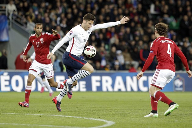 France’s Olivier Giroud, center, controls the ball as he challenged by Denmark's Simon Poulsen, left, and Erik Sviatchenko during their friendly soccer match at Geoffroy Guichard stadium in Saint-Etienne, central France, Sunday, March 29, 2015. (AP Photo/Laurent Cipriani)