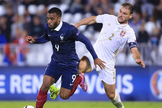 BELGRADE, SERBIA - SEPTEMBER 07: Alexandre Lacazette (L) of France is challenged by Branislav Ivanovic (R) of Serbia during the International friendly match between Serbia and France at the Stadium JNA on September 07, 2014 in Belgrade, Serbia, 2014. (Photo by Srdjan Stevanovic/Getty Images)