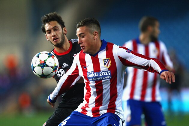 MADRID, SPAIN - MARCH 17:  Jose Gimenez of Atletico Madrid and Hakan Calhanoglu of Bayer Leverkusen compete for the ball during the UEFA Champions League round of 16 match between Club Atletico de Madrid and Bayer 04 Leverkusen at Vicente Calderon Stadium on March 17, 2015 in Madrid, Spain.  (Photo by Gonzalo Arroyo Moreno/Getty Images)