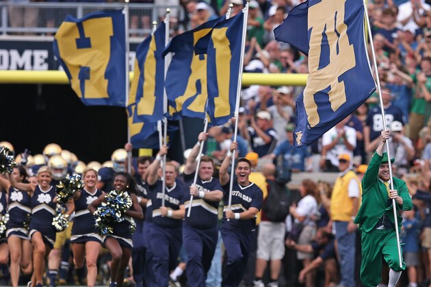 SOUTH BEND, IN - AUGUST 30:  The Notre Dame mascot The Leprechan, leads cheerleaders onto the field before a game between of the Notre Dame Fighting Irish and the Rice Owls at Notre Dame Stadium on August 30, 2014 in South Bend, Indiana. Notre Dame defeated Rice 48-17.  (Photo by Jonathan Daniel/Getty Images)