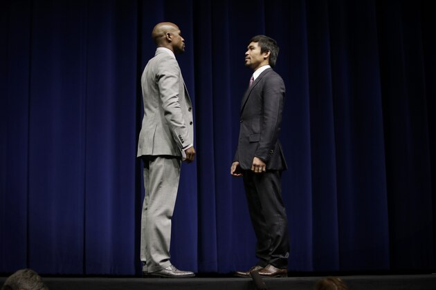 Floyd Mayweather Jr., left, and Manny Pacquiao, of the Philippines, pose for photos during a news conference, Wednesday, March 11, 2015, in Los Angeles. The two are scheduled to fight in Las Vegas on May 2. (AP Photo/Jae C. Hong)