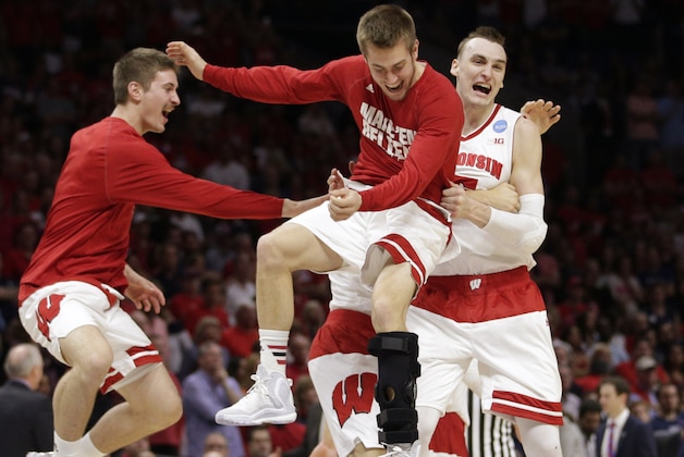 Wisconsin forward Sam Dekker, right, celebrates with teammates after beating Arizona 85-78 in a college basketball regional final in the NCAA Tournament, Saturday, March 28, 2015, in Los Angeles. Wisconsin will play in the Final Four in Indianapolis. (AP Photo/Jae C. Hong)
