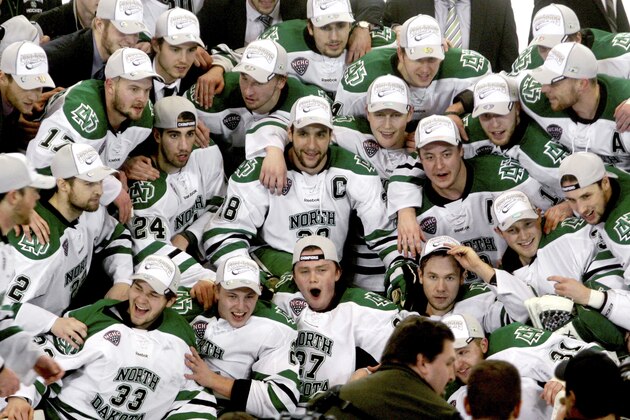 North Dakota players pose for a team picture following their 4-1 win over St. Cloud State during the West Regional final of the NCAA college hockey tournament Saturday, March 28, 2015, in Fargo, N.D. (AP Photo/Bruce Crummy)
