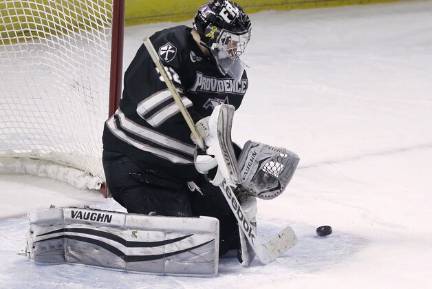 Providence goalie Jon Gillies deflects a Denver shot during the second period of the NCAA college hockey tournament East Regional final, Sunday, March 29, 2015, in Providence, R.I. Providence won 4-1 and advanced to the Frozen Four. (AP Photo/Steven Senne)