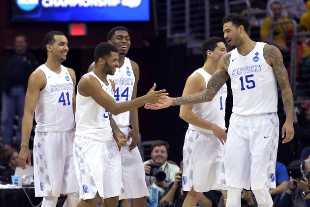 Kentucky's Andrew Harrison is congratulated by Willie Cauley-Stein (15) during the second half of a college basketball game against West Virginia in the NCAA men's tournament regional semifinals, Thursday, March 26, 2015, in Cleveland. (AP Photo/David Richard)
