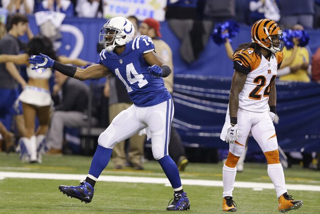 Indianapolis Colts' Hakeem Nicks (14) celebrates in front of Cincinnati Bengals' Adam Jones (24) following a catch during the first half of an NFL wildcard playoff football game, Sunday, Jan. 4, 2015, in Indianapolis. (AP Photo/Michael Conroy)