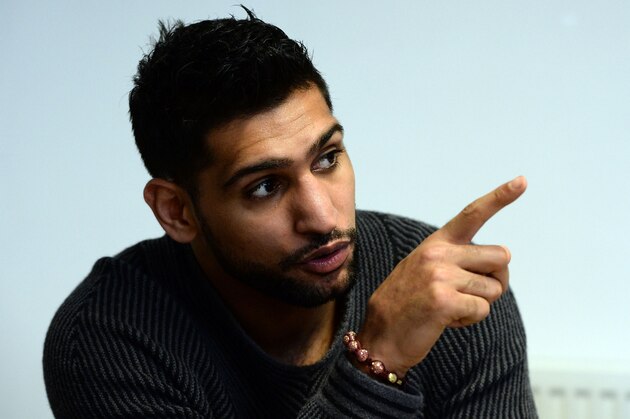 SHEFFIELD, ENGLAND - FEBRUARY 19:  Boxer Amir Khan speaks to media during a visit to Fight Label who make his shorts on February 19, 2015 in Sheffield, England.  (Photo by Nigel Roddis/Getty Images)