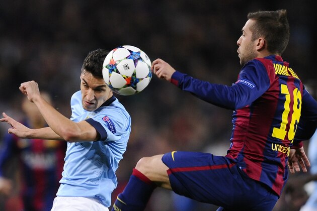 Barcelona's Jordi Alba, right, challenges Manchester City's Jesus Navas, left, during a Champions League round of 16 second leg, soccer match between FC Barcelona and Manchester City at Camp Nou stadium, in Barcelona, Spain, Wednesday, March 18, 2015. (AP Photo/Manu Fernandez)